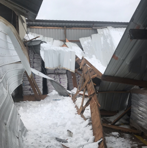 Image of a collapsed building covered in ice and snow