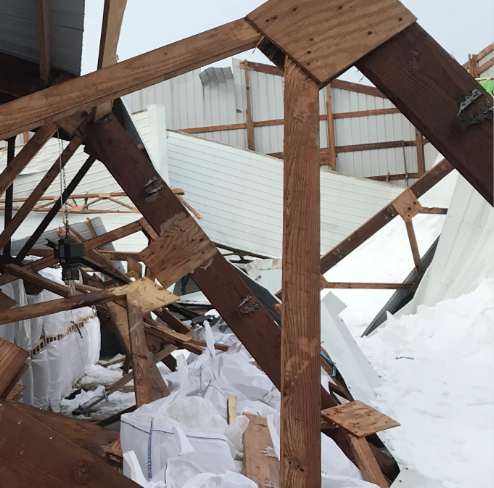 Image of a collapsed building covered in ice and snow